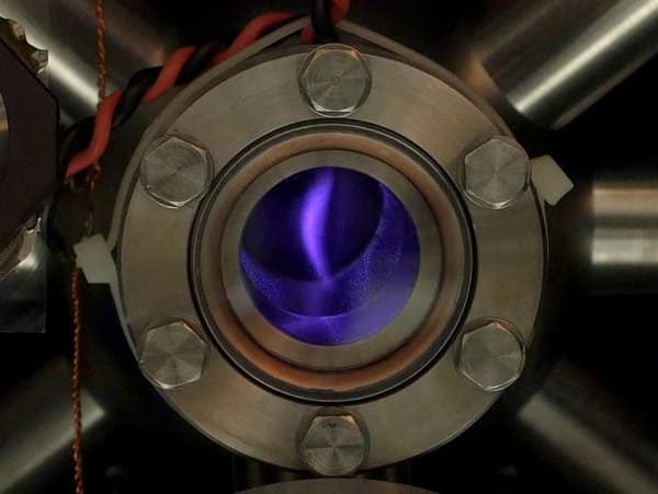 Infrared photo of the vacuum chamber showing the fluorescing cloud of caesium atoms